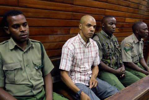 Jermaine John Grant, a British man accused of helping plan attacks, is guarded by Kenyan prison warders as he sits in the dock at the Mombasa Law Court in the coastal city of Mombasa, Kenya, May 9, 2019. PHOTO BY REUTERS/Joseph Okanga