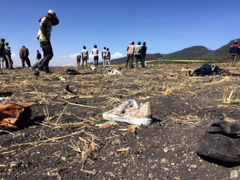 People walk at the scene of the Ethiopian Airlines Flight ET 302 plane crash. PHOTO BY REUTERS/Tiksa Negeri