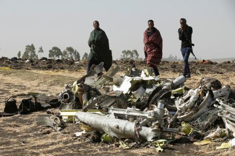 Ethiopian police officers walk past the debris of the Ethiopian Airlines Flight ET 302 plane crash, near the town of Bishoftu, near Addis Ababa, Ethiopia, March 12, 2019. PHOTO BY REUTERS/Baz Ratner