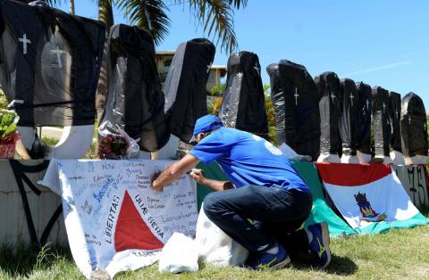 Black plastic bags with taped crosses cover stone letters of the name Brumadinho, after a dam owned by Brazilian mining company Vale SA collapsed, in Brumadinho, Brazil, February 1, 2019. PHOTO BY REUTERS/Washington Alves