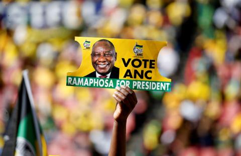 A supporter holds a placard with the face of President of South Africa's governing African National Congress Cyril Ramaphosa, during the party's final rally at Ellis Park Stadium in Johannesburg, South Africa, May 5, 2019. REUTERS/Siphiwe Sibeko