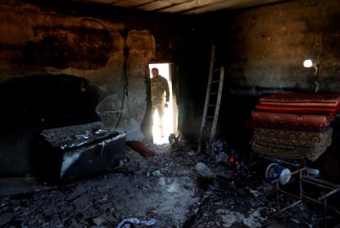 A fighter loyal to Libya's U.N.-backed government (GNA) looks at a room burned during clashes with troops loyal to Khalifa Haftar in Wadi Rabiya neighbourhood at outskirts of Tripoli, Libya, May 28, 2019. PHOTO BY REUTERS/Goran Tomasevic