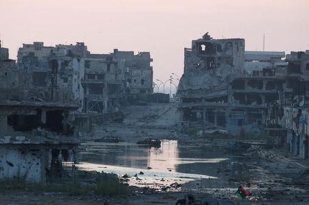 Damaged homes are seen after clashes between members of the Libyan pro-government forces, backed by the locals, and Shura Council of Libyan Revolutionaries, an alliance of former anti-Gaddafi rebels who have joined forces with Islamist group Ansar al-Sharia, in Benghazi, Libya July 7, 2015. PHOTO BY REUTERS/Stringer