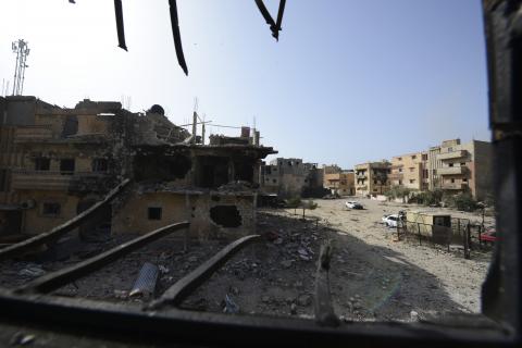 Homes are seen damaged after clashes between members of the Libyan pro-government forces, backed by the locals, and Shura Council of Libyan Revolutionaries, an alliance of former anti-Gaddafi rebels who have joined forces with Islamist group Ansar al-Sharia, in Benghazi, January 21, 2015. PHOTO BY REUTERS/Esam Omran Al-Fetori