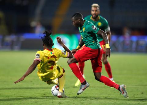 Benin's David Djigla in action with Cameroon's Ambroise Oyono. PHOTO BY REUTERS/Amr Abdallah Dalsh