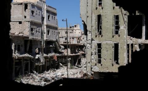 Debris from damaged buildings are seen from a hole at a rebel-held area in Deraa, Syria, August 2, 2017. PHOTO BY REUTERS/Alaa al-Faqir