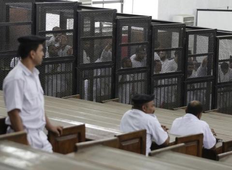 Islamist defendants stand behind bars in the case known as the "Kerdasa massacre'', that referred 188 people to court over an attack that killed 14 policemen in Cairo in 2013. PHOTO BY REUTERS/Asmaa Waguih