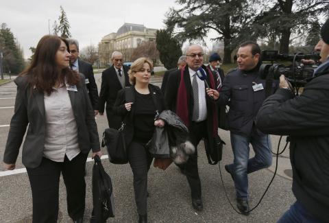 Members of Syrian opposition delegation Rima Fleihan (L), and Suheir Attasi (2nd L) and Abdulahad Astepho (3rd L) speak to a journalist as they arrive for their first meeting face to face with Syrian government delegation and U.N.-Arab Leagues representatives