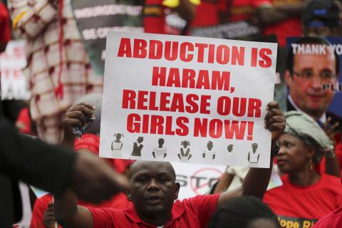 A man holds a placard calling for the release of secondary school girls abducted in the remote village of Chibok, during a protest along a road in Lagos