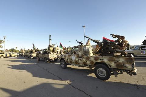 Demonstrators protest against armed militias as they welcome the arrival of the Libyan army in Benghazi