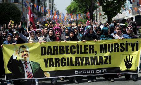 Pro-Islamist demonstrators hold a banner that reads "Coup leaders can't trial Mursi" during a protest in support former President Mohamed Mursi at the courtyard of Fatih mosque in Istanbul, Turkey, May 17, 2015. PHOTO BY REUTERS/Yagiz Karahan