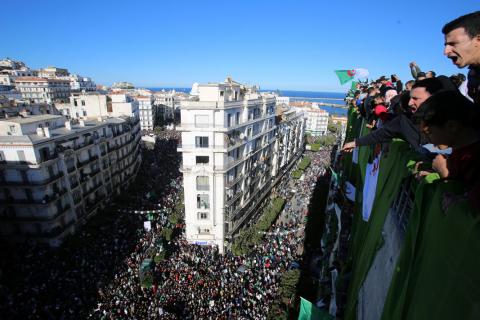 Demonstrators stand atop of a building during a protest over President Abdelaziz Bouteflika's decision to postpone elections and extend his fourth term in office, in Algiers, Algeria, March 15, 2019. PHOTO BY REUTERS/Ramzi Boudina