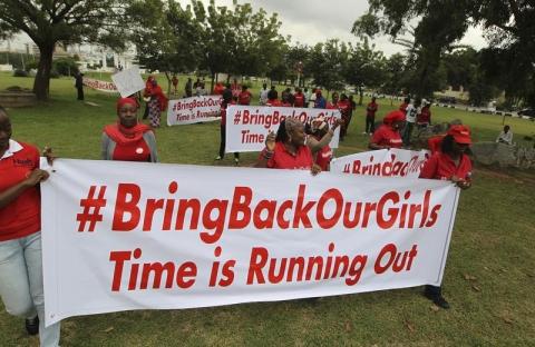 Demonstrators hold up banners during a rally that was held to mark the 120th day since the abduction of two hundred school girls by the Boko Haram, in Abuja