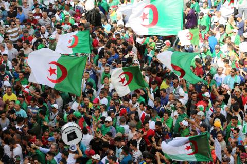 Demonstrators gesture and carry flags during a protest demanding the removal of the ruling elite and prosecution of former officials linked to former President Abdelaziz Bouteflika, in Algiers, Algeria, June 14, 2019. PHOTO BY REUTERS/Ramzi Boudina