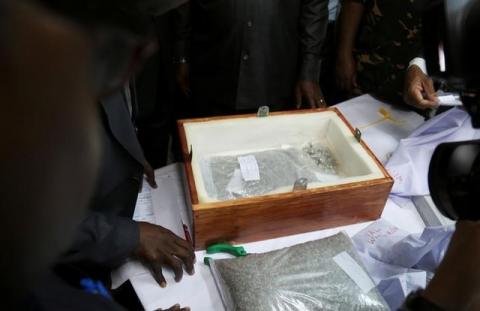 Tanzanian government officials look at a consignment of diamond seized at the airport in Dar es Salaam Tanzania, September 9, 2017. PHOTO BY REUTERS/Stringer