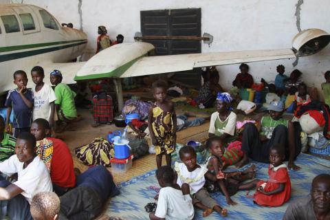 People displaced by fighting between rival militias take shelter next to an old broken airplane at the airport in Bangui, Central African Republic