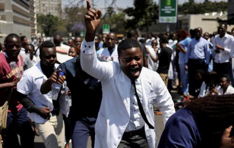 Doctors sing and hold placards during a protest over the disappearance of the leader of their union in Harare, Zimbabwe, September 16, 2019. PHOTO BY REUTERS/Siphiwe Sibeko