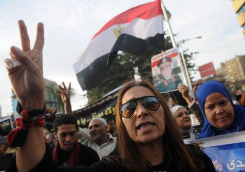 An Egyptian woman gestures during a protest against what they say is Qatar's backing of ousted Egyptian president Mohamed Mursi's government, outside the Qatari Embassy in Cairo