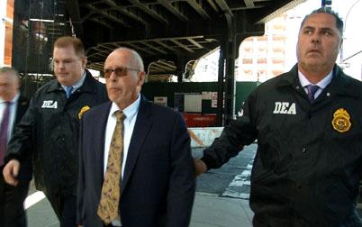 Laurence Doud III, the former CEO of Rochester Drug Cooperative Inc. is escorted by Federal Drug Enforcement Administration (DEA) agents after the U.S. government charged Doud with conspiring to distribute illegal narcotics and conspiring to defraud the United States, in this still image taken from video, in New York, U.S., April 23, 2019. PHOTO BY REUTERS/Reuters TV