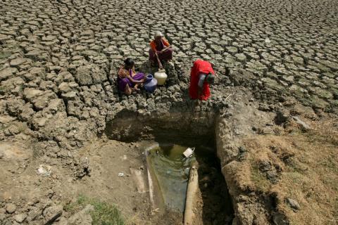  Women fetch water from an opening made by residents at a dried-up lake in Chennai, India, June 11, 2019. PHOTO BY REUTERS/P. Ravikumar