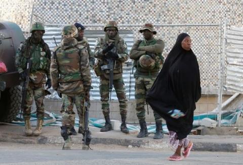 A woman passes near members of the regional ECOWAS, in Banjul, Gambia, January 23, 2017. PHOTO BY REUTERS/Thierry Gouegnon