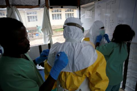 Health workers dress in Ebola protective suits before starting their shift at an Ebola transit centre in the town of Katwa near Butembo, in the Democratic Republic of Congo, March 25, 2019. PHOTO BY REUTERS/Baz Ratner