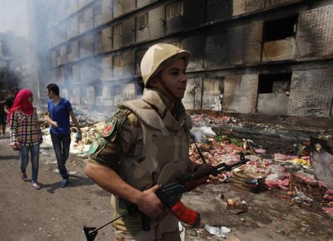 Egyptian soldier and a couple walk