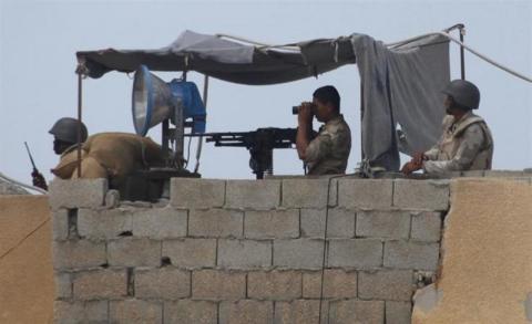 Egyptian soldiers keep guard on the border between Egypt and the southern Gaza Strip