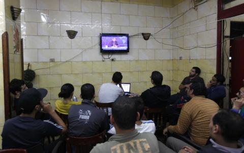 Egyptians watch the first episode of a show by Egypt's most prominent television satirist, Bassem Youssef, called "Al-Bernameg" (The Programme) in Cairo