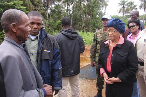 Liberian President Ellen Johnson-Sirleaf speaks to villagers about Ebola virus precautions outside Ganta, Liberia