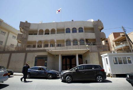 A man walks past the South Korean embassy after it was attacked by gunmen in Tripoli, April 12, 2015. PHOTO BY REUTERS/Ismail Zitouny