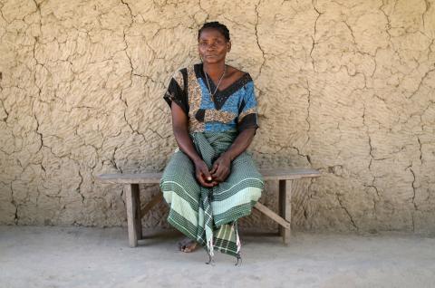 Ernestina, 50, whose son died in an attack by armed men, sits in front of a mud hut in Chitolo village, Mozambique, July 10, 2018. PHOTO BY REUTERS/Mike Hutchings