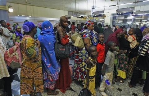 Refugees fleeing escalating violence in the Central African Republic, wait in line at the Nnamdi Azikiwe International Airport in Abuja