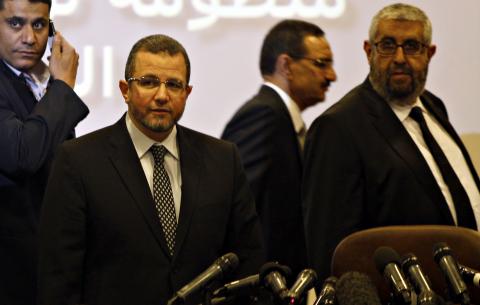 Egypt's Prime Minister Hisham Kandil (2nd L) is seen with Sherif Haddara (R), Minister of Petroleum at news conference about a new "smart card" system to track purchases of subsidised fuel