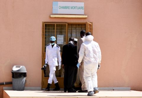 Forensic experts and medics are pictured at the door of the morgue of the Bogodogo District Hospital in Ouagadougou, where bodies had been registered after an attack on a road leading to the Boungou mine, operated by Canadian gold miner Semafo, Burkina Faso, November 8, 2019. PHOTO BY REUTERS/Anne Mimault