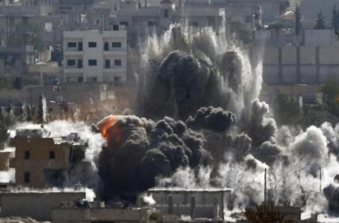 An explosion following an air-strike is seen in the Syrian town of Kobani from near the Mursitpinar border crossing on the Turkish-Syrian border in the southeastern town of Suruc in Sanliurfa province, October 29, 2014. PHOTO BY REUTERS/Yannis Behrakis