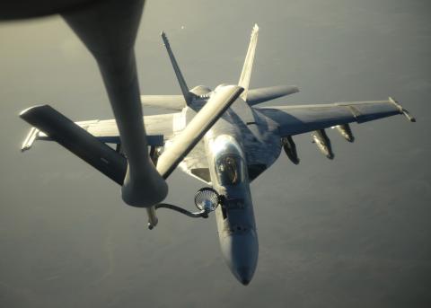 A U.S. Navy F-18E Super Hornet receives fuel from a KC-135 Stratotanker over northern Iraq after conducting air strikes in Syria