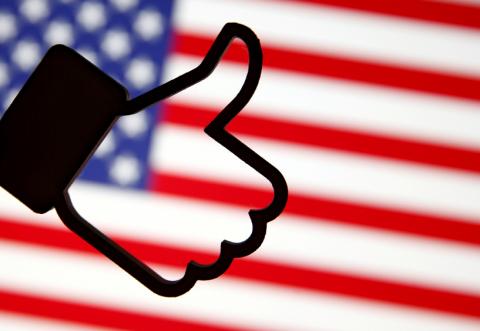 A 3D-printed Facebook Like symbol is displayed in front of a U.S. flag in this illustration taken, March 18, 2018. PHOTO BY REUTERS/Dado Ruvic/Illustration