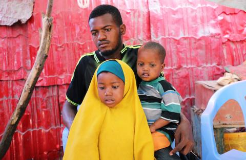 Somali farmer Abdi Abukar Hassan and father of Mohamed Abdul, who was injured in the car bomb attack at the Afgoye junction, sits with his son Sadak Abdi and daughter Khadija Abdi, during a Reuters interview outside his house in Mogadishu, Somalia, on January 1, 2020. PHOTO BY REUTERS/Feisal Omar