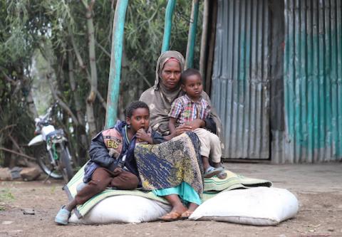 Asha Khalif Ali, 35, an internally displaced Ethiopian sits on bags of rotten wheat which was ruined by heavy rain and desert locusts, Tuli Guled, Somali Region, Ethiopia, January 13, 2020. PHOTO BY REUTERS/Giulia Paravicini