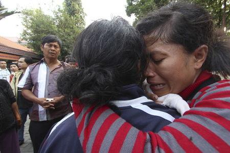 A family member of a victim from an Indonesian military C-130 Hercules transport plane that crashed into a residential area, cries at Adam Malik hospital in the North Sumatra city of Medan, Indonesia, June 30, 2015, in this photo taken by Antara Foto. PHOTO BY REUTERS/Septianda Perdana