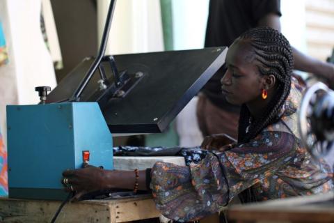 Fatou Kine presses clothes in her shop in Guediawaye, Senegal, April 16, 2018. PHOTO BY REUTERS/Mikal McAllister