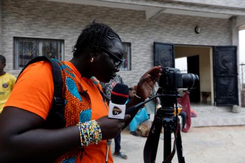 Fatou Warkha, 30, an activist who founded the community web TV Warkhatv.com, prepares her equipment before shooting footage in the streets of Pikine, on the outskirts of Dakar, Senegal, January 23, 2020. PHOTO BY REUTERS/Zohra Bensemra