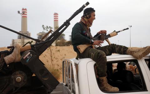 A fighter from Misrata sits on top of a vehicle near Sirte, March 16, 2015. PHOTO BY REUTERS/Goran Tomasevic