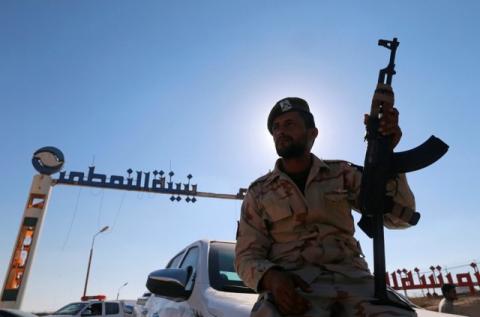 A member of Libyan forces loyal to eastern commander Khalifa Haftar holds a weapon as he sits on a car in front of the gate at Zueitina oil terminal in Zueitina, west of Benghazi, Libya, September 14, 2016. PHOTO BY REUTERS/Esam Omran Al-Fetori