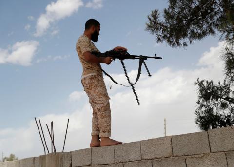 A member of the Libyan internationally recognised government fires a rifle at outskirts of Tripoli, Libya, May 12, 2019. PHOTO BY REUTERS/Goran Tomasevic