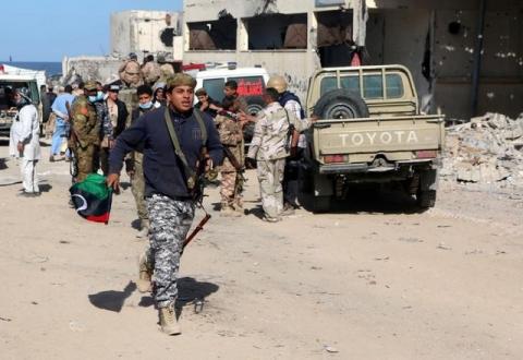 A fighter of Libyan forces allied with the U.N.-backed government runs as forces clear Ghiza Bahriya. PHOTO BY REUTERS/Hani Amara