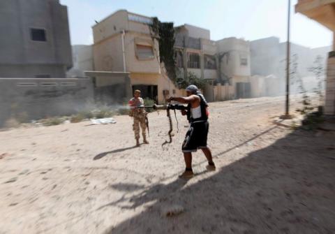 A member of Libyan forces allied with the UN-backed government fires a weapon towards Islamic State militants in neighbourhood Number One in central Sirte, Libya, August 28, 2016. PHOTO BY REUTERS/Ismail Zitouny