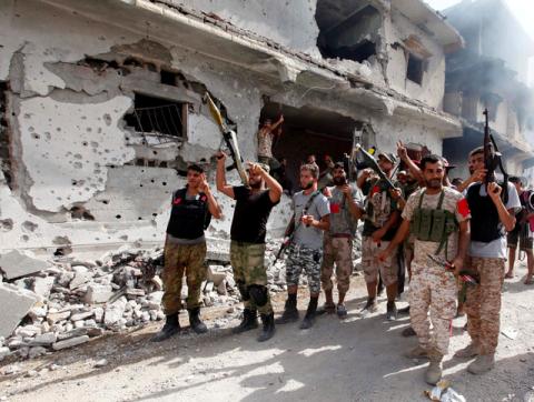 Fighters from Libyan forces allied with the U.N.-backed government gesture as they advance into the last area controlled by Islamic State, in Sirte, Libya, October 14, 2016. PHOTO BY REUTERS/Ismail Zitoun