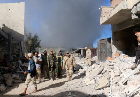 Fighters of Libyan forces allied with the U.N.-backed government gather as smokes rises following an air strike on Islamic State positions in Ghiza Bahriya district in Sirte, Libya, November 22, 2016. PHOTO BY REUTERS/Hani Amara